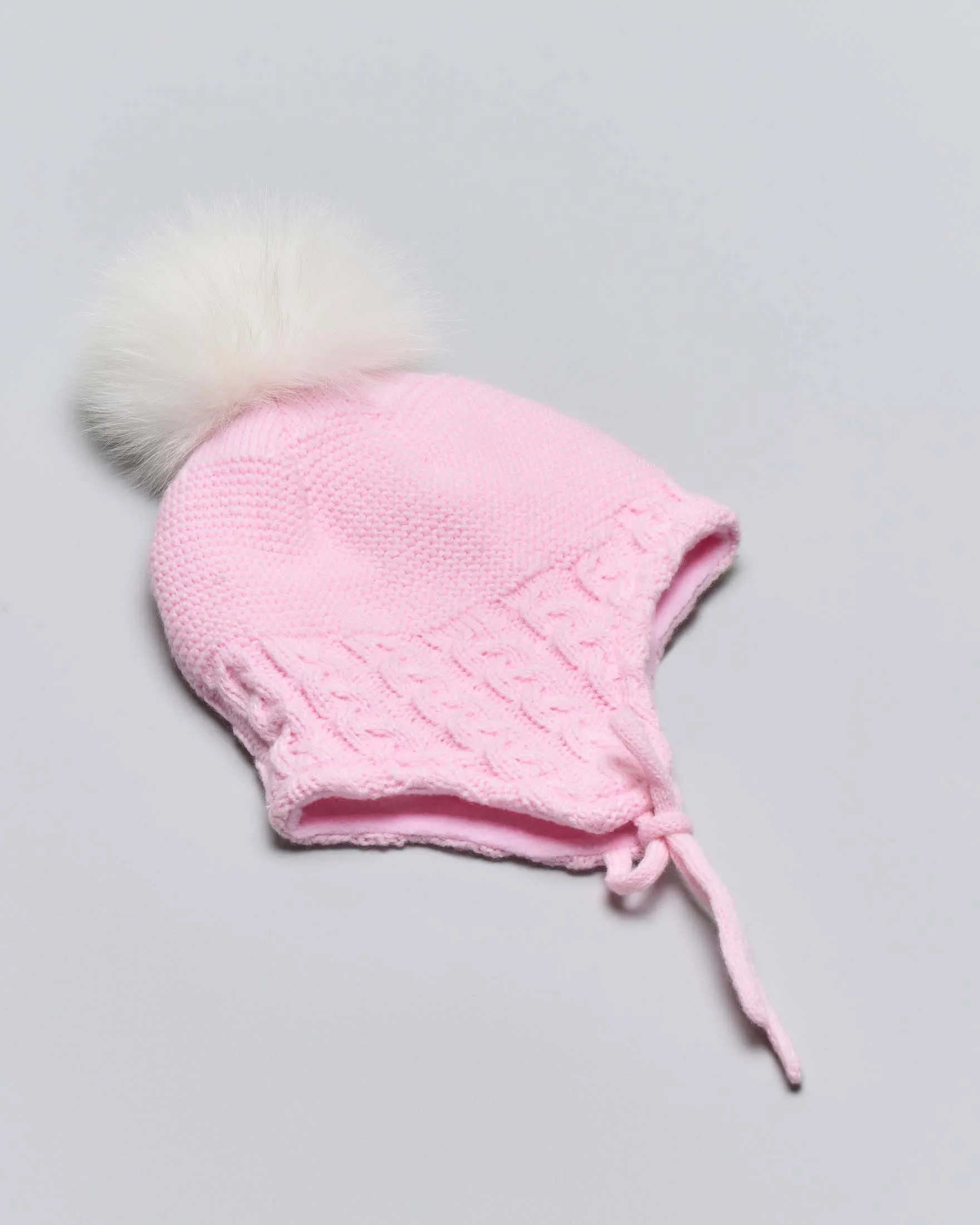 Berretto rosa a trecce con paraorecchie pompon e fiocchetti applicati 3-7 anni